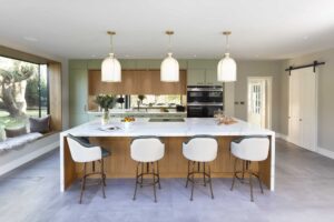 Contemporary Green and Stained Oak kitchen with waterfall island