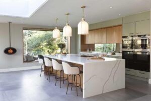 Contemporary Green and Stained Oak kitchen with waterfall island