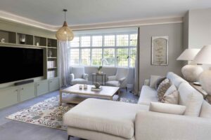 Contemporary kitchen and living room with media unit in olive green